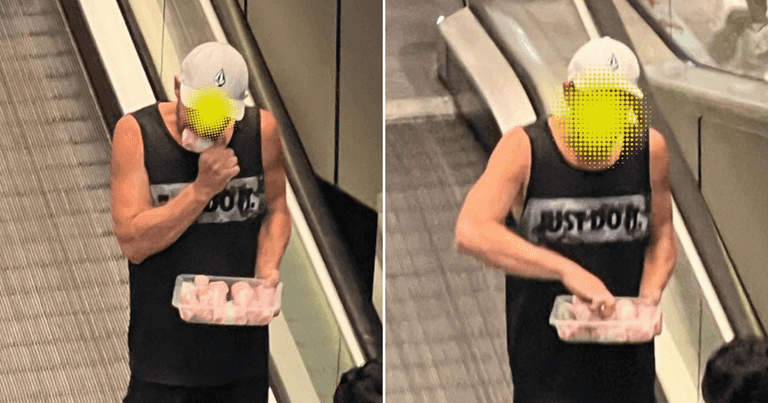 Man spotted eating raw chicken drumsticks straight out of the packet Man spotted eating raw chicken drumsticks straight out of the packet