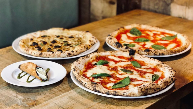 three pizzas, one with a white base, and a cannoli