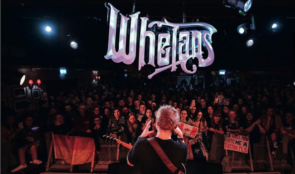 Ed Sheeran on stage taking a photo of the crowd at whelans