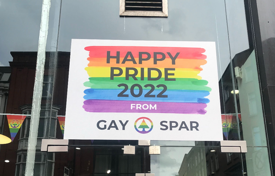 rainbow coloured sign in a shop window which reads "Happy Pride 2022 from Gay Spar"