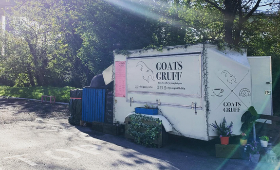 cream-coloured food truck with trees in the background, sign reads 'Goats Gruff'